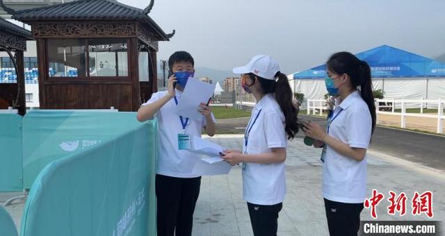 马术赛场上的志愿面孔:背对精彩比赛 面向观众微笑